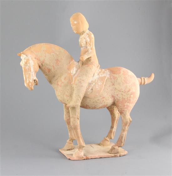 A Chinese polychrome painted pottery group of a horse and rider, Tang dynasty or later, height 36.5cm